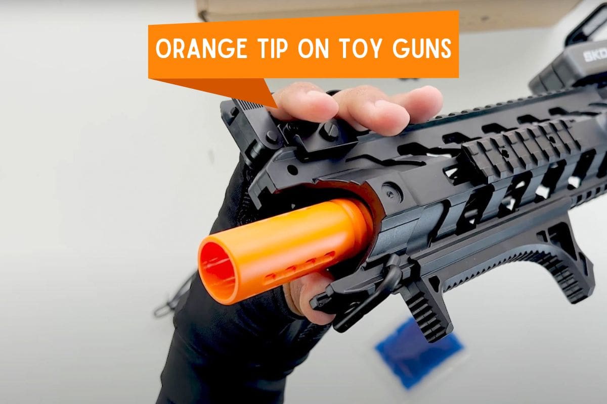 Toy gun with orange tip on barrel